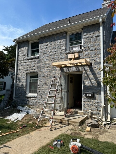 home in progress of restoring natural stone on front facing wall