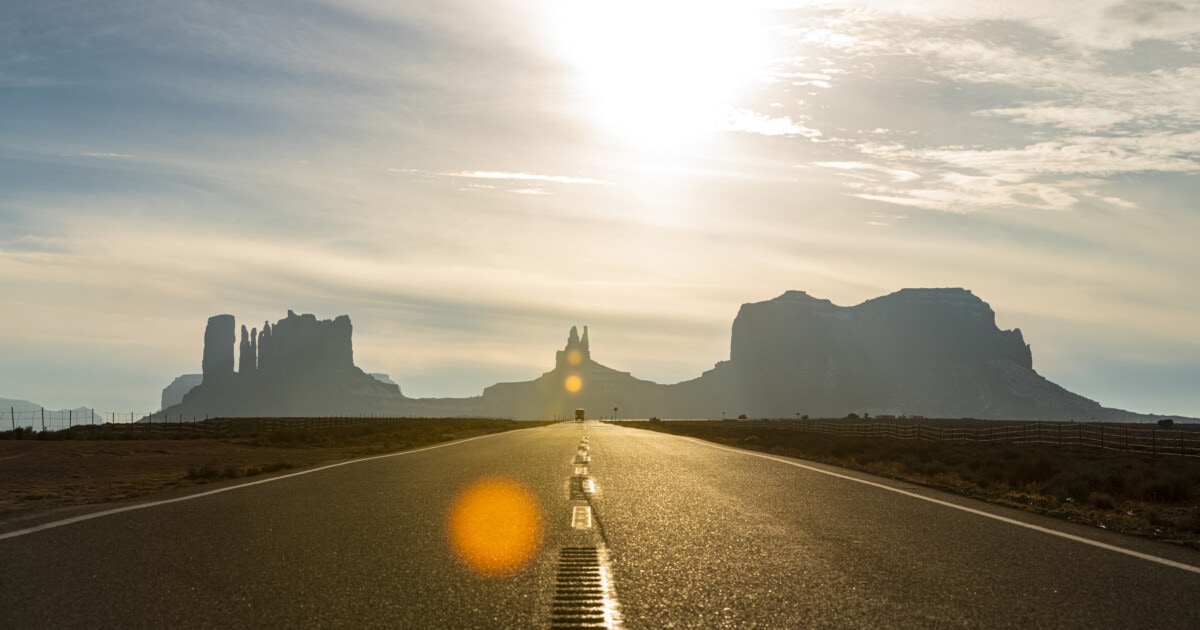 Bus driving on a highway in Monument Valley, New Mexico, USA