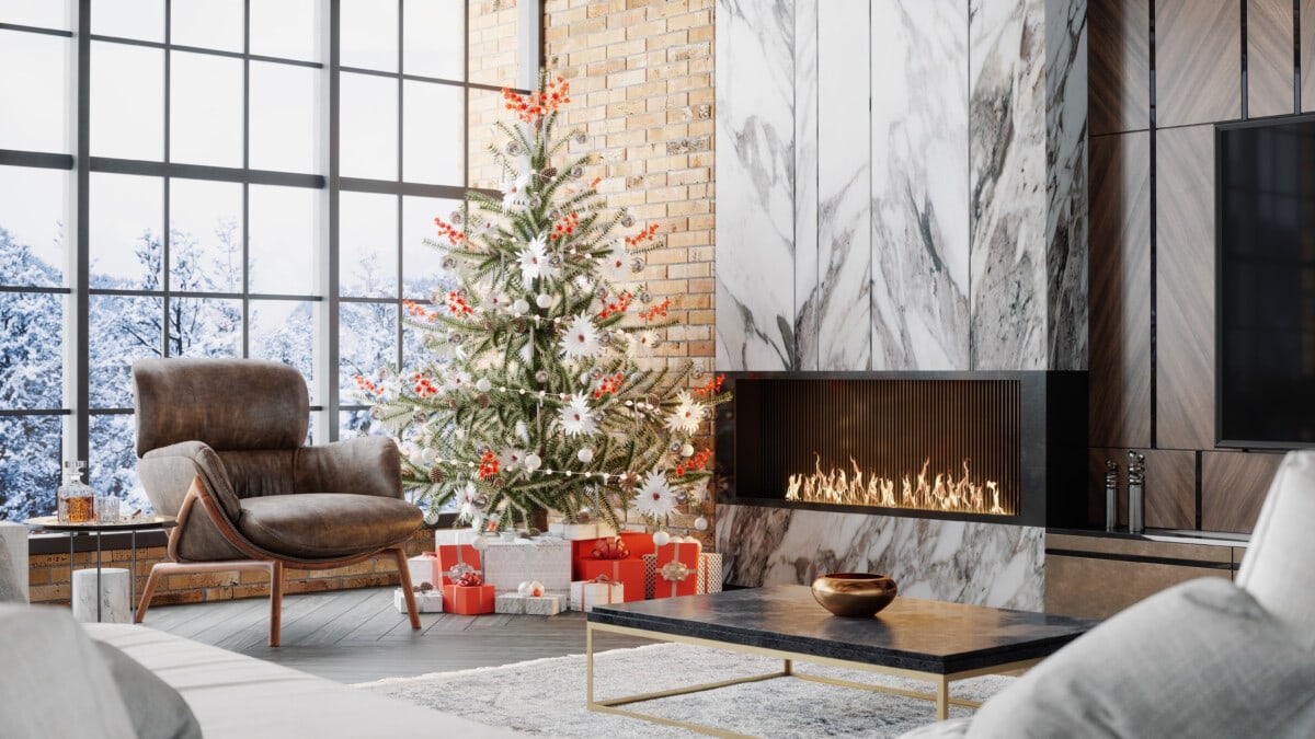 Fireplace, christmas tree and presents in a luxurious chalet with snowy mountain view.