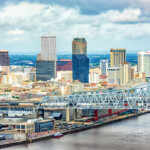 downtown new orleans skyline with clouds and river_Getty