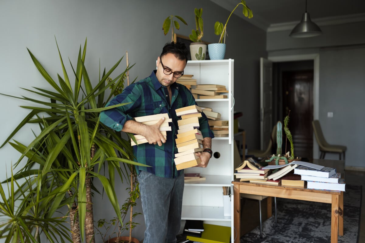 Man organizing his book collections