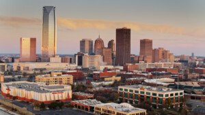 Aerial shot of Oklahoma City at sunrise, looking across Bricktown towards the downtown skyline.