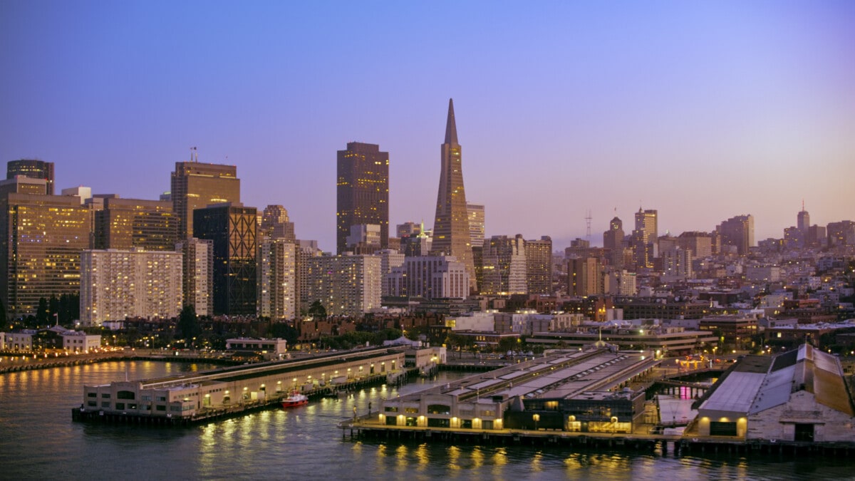 Aerial view of commercial dock against city during dusk, San Francisco, California, USA.