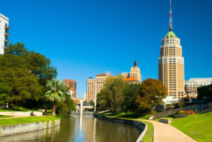 San Antonio downtown skyline with the riverwalk in the foreground.