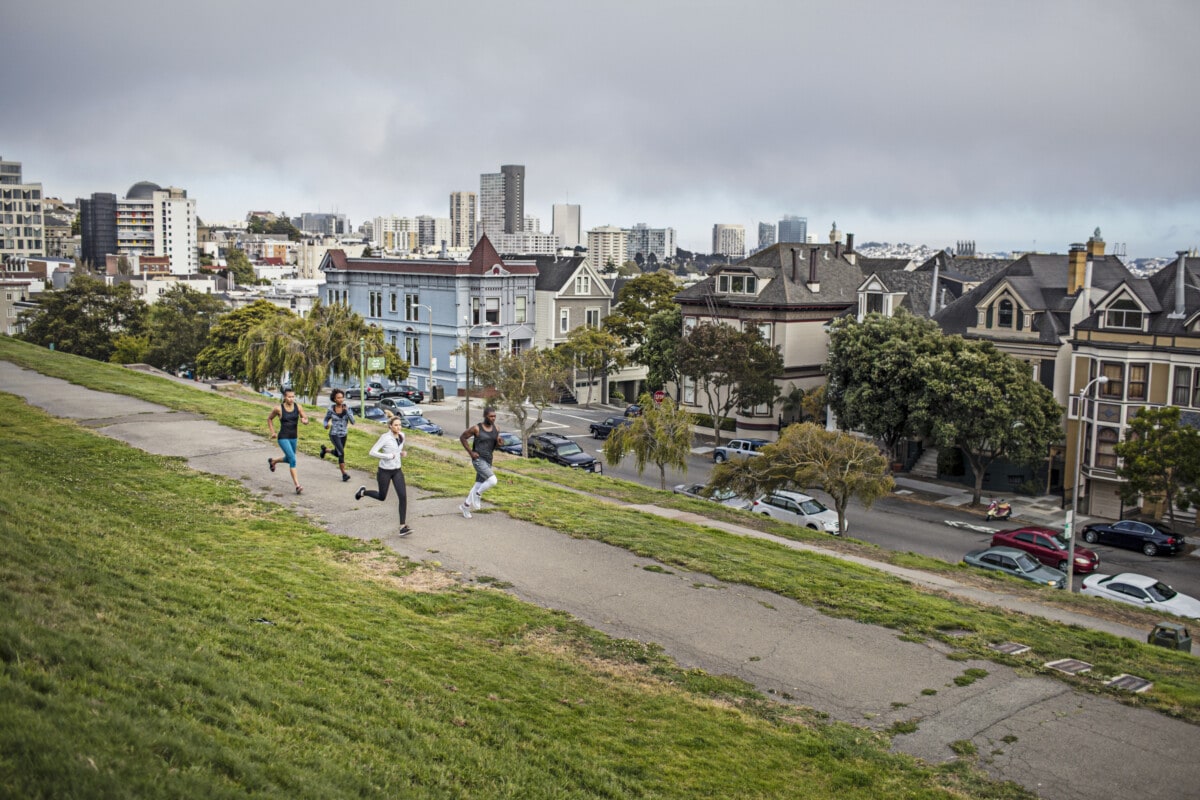 Four people running on a park in San Francisco, USA.