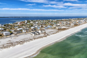 Beautiful homes along the Gulf Coast beach at Pensacola Beach, Florida shot from an altitude of about 600 feet over the Gulf of Mexico.