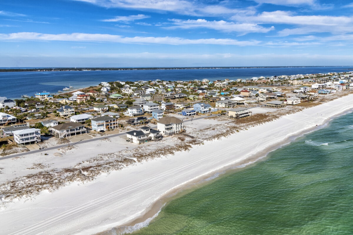 Beautiful homes along the Gulf Coast beach at Pensacola Beach, Florida shot from an altitude of about 600 feet over the Gulf of Mexico.