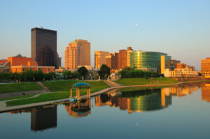 "Dayton, Ohio skyline right at sunrise w/ skyline reflections on the River."