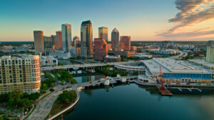 Aerial shot of Tampa, Florida at sunrise. Drone grabs views of downtown and surrounding area from waterways leading to Tampa Bay