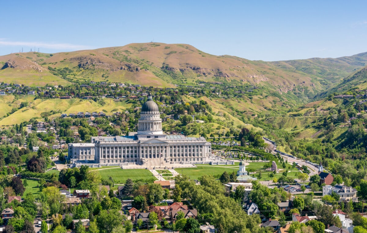 A high angle view of Utah's State Capitol building, flanked by mountains, in the north of Salt Lake City, Utah.