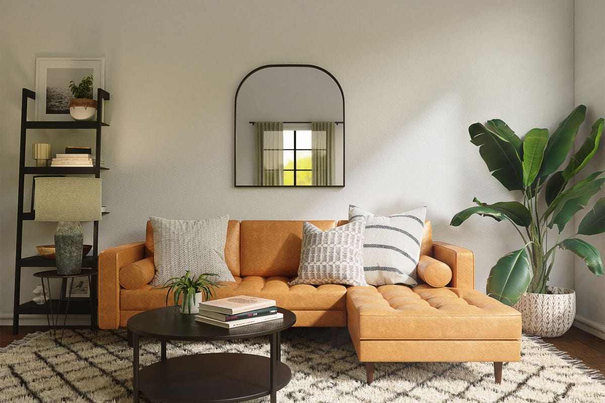 room with orange couch and pillows