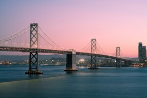 bay bridge at dusk with oakland in the background
