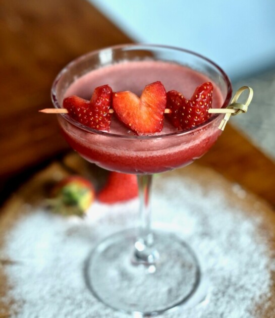 Strawberry cocktail with heart-shaped strawberries as garnish