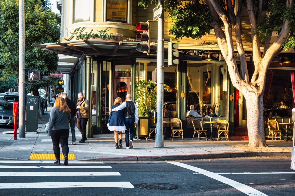 people walking on sidewalk in hayes valley san francisco in front of absinthe restaurant and bar