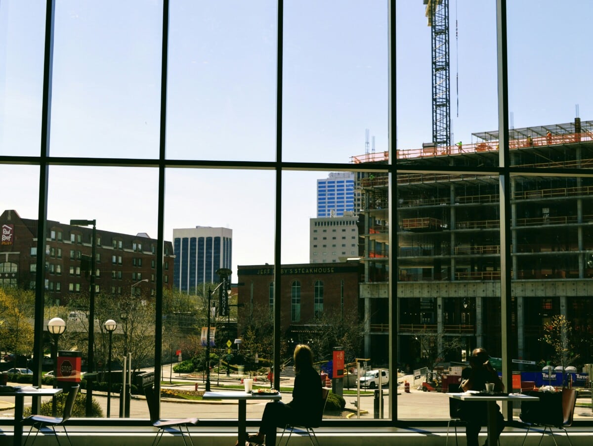 view from inside a building with large windows overlooking a street in arena district