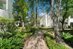 wooded walking path through condominiums in river park sacramento