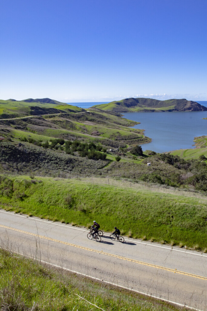 two people biking along the coast, a popular San Luis Obispo bucket list item