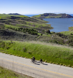 two people biking along the coast, a popular San Luis Obispo bucket list item