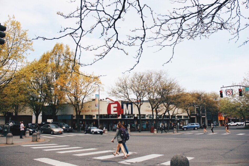 Photo of two people crossing the street in Downtown Bellingham, a place to stop on the ultimate Bellingham bucket list