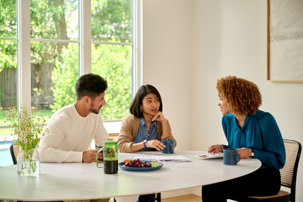 Couple discusses the process of selling a house with a mortgage with their real estate agent