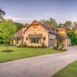 Stone suburban home with manicured lawn at sunset, highlighting days on market real estate.