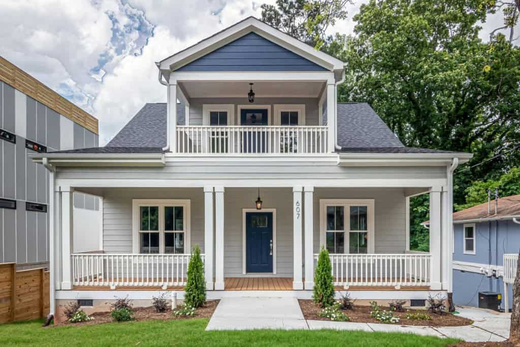 Two story house with a manicured lawn.