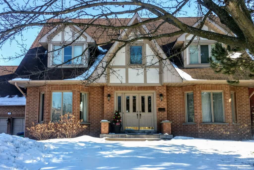 exterior of a house with a snow-y lawn