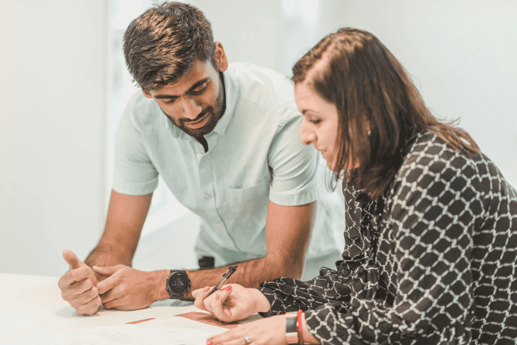 Real estate agent explaining paperwork and offering real estate advice for buyers during a consultation