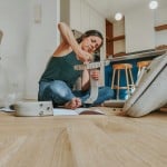 Lady on the floor fixing something