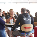 Redfin employees sit at a lunch table