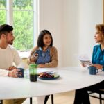 Couple sitting at table with real estate agent